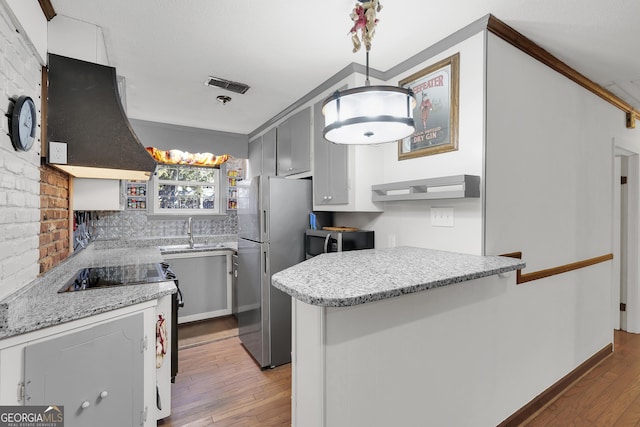 215 Cedar St, Anderson, SC 29626 - kitchen featuring visible vents, light wood-type flooring, exhaust hood, and appliances with stainless steel finishes