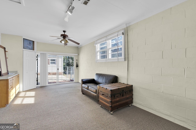 215 Cedar St, Anderson, SC 29626 - living area with visible vents, ceiling fan, carpet, concrete block wall, and rail lighting