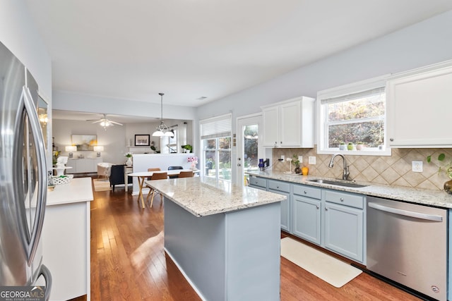 2319 White Alder Dr, Buford, GA 30519 - kitchen featuring tasteful backsplash, a sink, appliances with stainless steel finishes, wood-type flooring, and pendant lighting