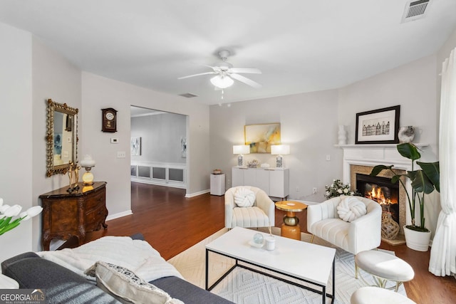 2319 White Alder Dr, Buford, GA 30519 - living area with visible vents, a ceiling fan, wood finished floors, and a glass covered fireplace