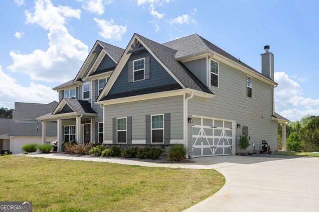 32 Winifred Way, Senoia, GA 30276 - craftsman-style house featuring a garage, concrete driveway, a front lawn, a chimney, and a shingled roof