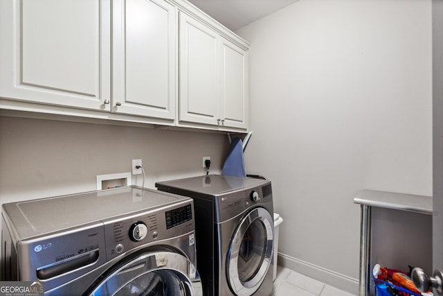 3105 Neal Ct, Cumming, GA 30041 - washroom with cabinet space, light tile patterned floors, washer and clothes dryer, and baseboards