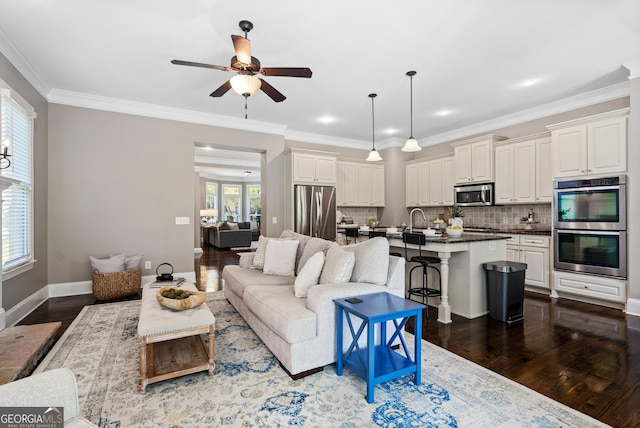 3105 Neal Ct, Cumming, GA 30041 - living area featuring a ceiling fan, crown molding, and dark wood-style floors