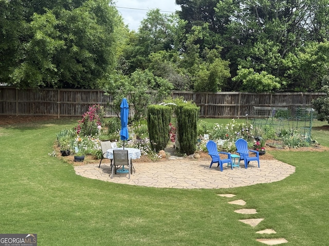 view of playground with a patio, fence, and a yard
