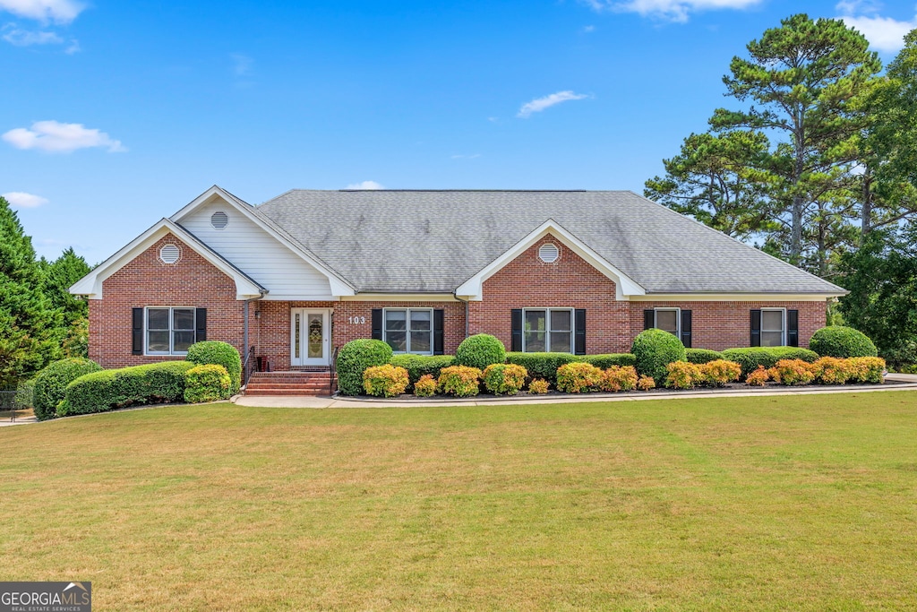 103 Wisteria Way, Stockbridge, GA 30281 - ranch-style house featuring brick siding, a front lawn, and roof with shingles