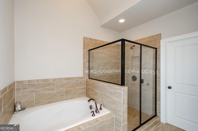 full bathroom featuring recessed lighting, a garden tub, a stall shower, and lofted ceiling