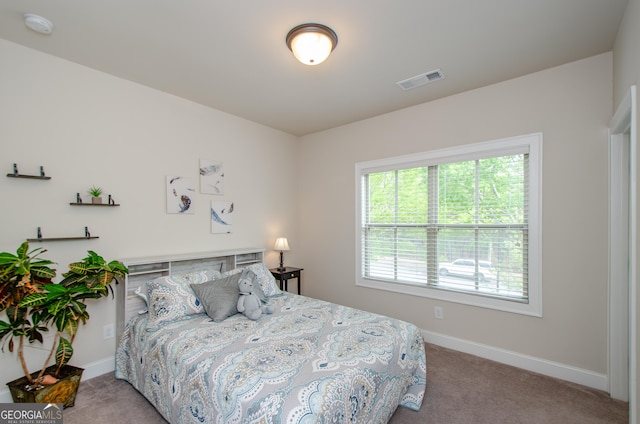 bedroom with carpet floors, baseboards, and visible vents