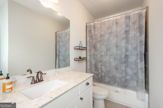bathroom featuring toilet, vanity, and shower / tub combo with curtain