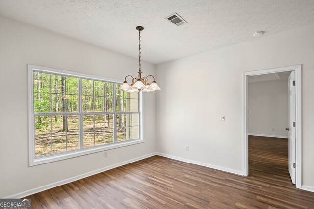 185 Cold Harbor Ct, Sharpsburg, GA 30277 - unfurnished dining area featuring a wealth of natural light, visible vents, an inviting chandelier, and dark wood finished floors