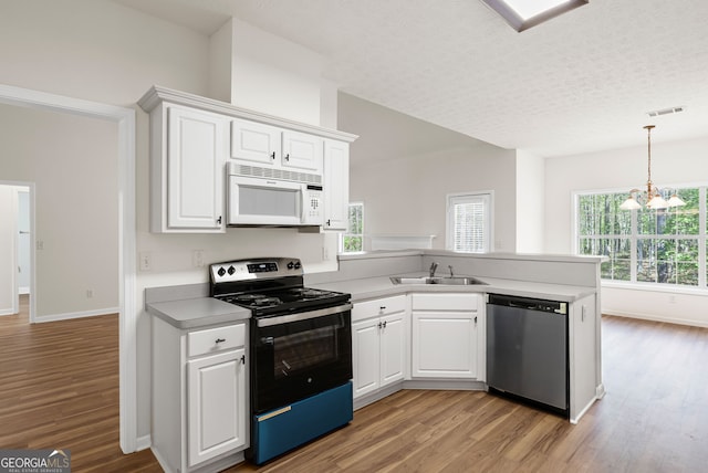 185 Cold Harbor Ct, Sharpsburg, GA 30277 - kitchen featuring white microwave, a peninsula, range with electric stovetop, light wood-style floors, and stainless steel dishwasher