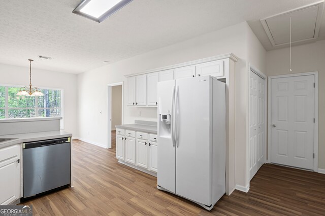 185 Cold Harbor Ct, Sharpsburg, GA 30277 - kitchen featuring white refrigerator with ice dispenser, wood finished floors, stainless steel dishwasher, and white cabinetry