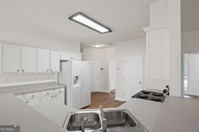 185 Cold Harbor Ct, Sharpsburg, GA 30277 - kitchen featuring white cabinets, light countertops, white refrigerator with ice dispenser, and a sink