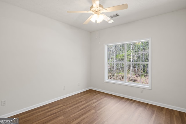 185 Cold Harbor Ct, Sharpsburg, GA 30277 - spare room featuring visible vents, baseboards, a ceiling fan, and wood finished floors