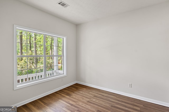 185 Cold Harbor Ct, Sharpsburg, GA 30277 - empty room with wood finished floors, baseboards, and visible vents