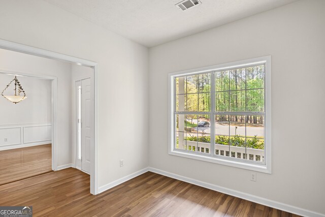 185 Cold Harbor Ct, Sharpsburg, GA 30277 - spare room featuring visible vents, baseboards, and wood finished floors