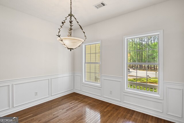 185 Cold Harbor Ct, Sharpsburg, GA 30277 - unfurnished dining area featuring dark wood finished floors, wainscoting, visible vents, and a decorative wall
