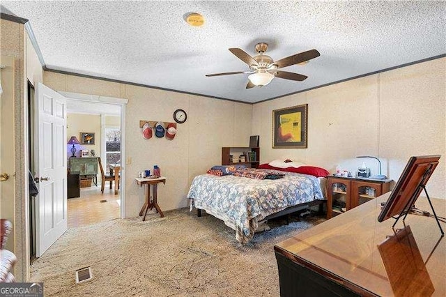 4941 N Helton Rd, Winston, GA 30187 - bedroom featuring visible vents, ceiling fan, a textured ceiling, crown molding, and carpet floors