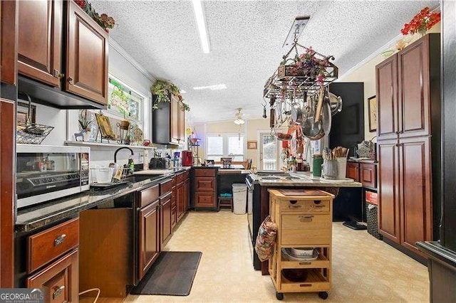 4941 N Helton Rd, Winston, GA 30187 - kitchen with ceiling fan, light floors, a textured ceiling, dark countertops, and a sink