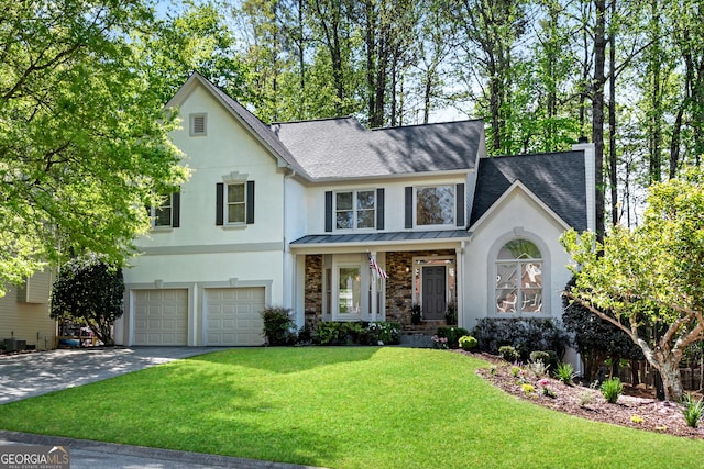 view of front facade with stucco siding, a standing seam roof, and a shingled roof