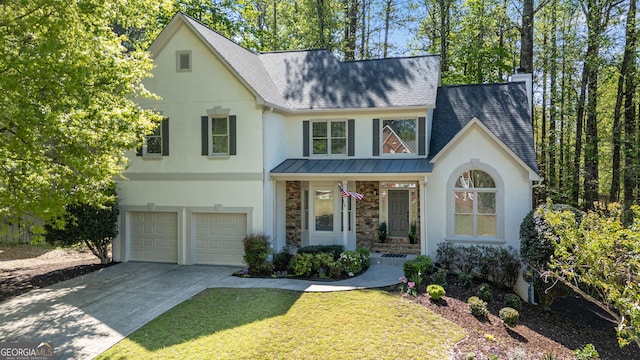 view of front of property featuring a shingled roof, stucco siding, and a garage
