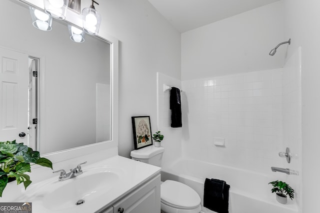 bathroom with toilet, vanity, and shower / bathtub combination