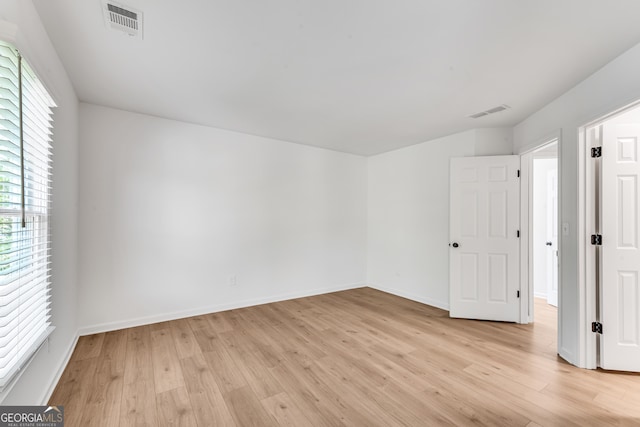 unfurnished bedroom featuring light wood-type flooring and baseboards
