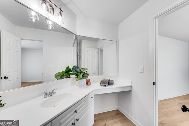 bathroom featuring wood finished floors and vanity