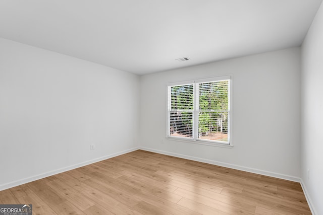 spare room with light wood-style flooring and baseboards