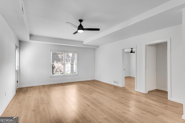 unfurnished room with a ceiling fan, baseboards, and light wood-style flooring