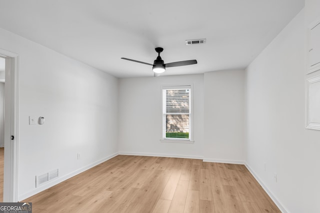unfurnished room featuring a ceiling fan, light wood finished floors, and baseboards
