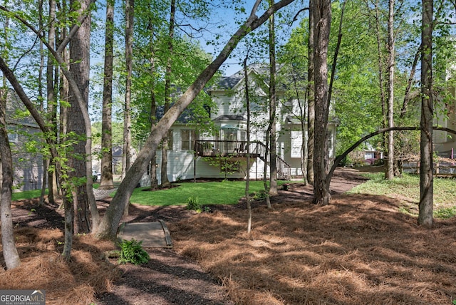 view of yard with a deck and stairs