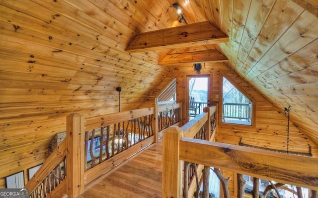 bonus room with vaulted ceiling with beams, wooden walls, wooden ceiling, and wood finished floors