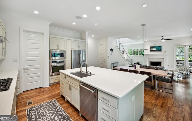 1155 Mcconnell Dr, Decatur, GA 30033 - kitchen featuring a fireplace, ornamental molding, a sink, stainless steel appliances, and open floor plan