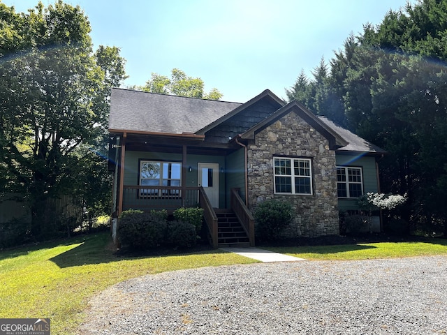 2389 Fair Field Dr, Hiawassee, GA 30546 - view of front of house featuring a front lawn, stone siding, a porch, and stairs