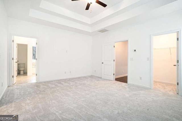 3514 Ambassador Aly, Scottdale, GA 30079 - unfurnished bedroom featuring a tray ceiling, visible vents, carpet floors, a walk in closet, and baseboards