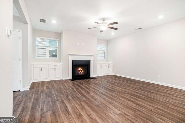 3514 Ambassador Aly, Scottdale, GA 30079 - unfurnished living room with a glass covered fireplace, visible vents, dark wood-style flooring, and a ceiling fan