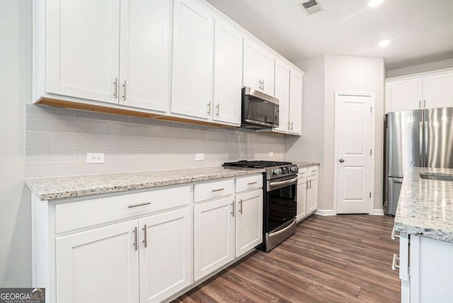 3514 Ambassador Aly, Scottdale, GA 30079 - kitchen with white cabinets, tasteful backsplash, visible vents, and stainless steel appliances
