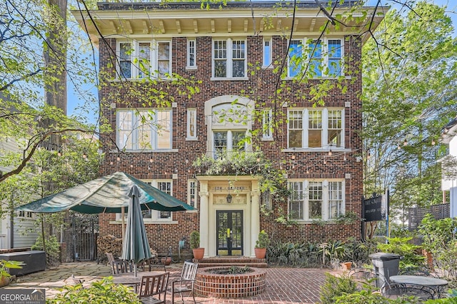 view of front of property with brick siding and french doors