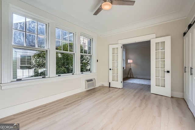 unfurnished sunroom with a wall mounted AC and french doors