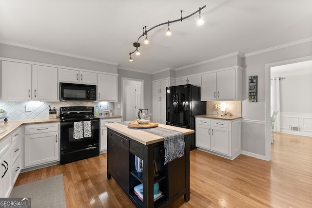 kitchen with white cabinetry and black appliances