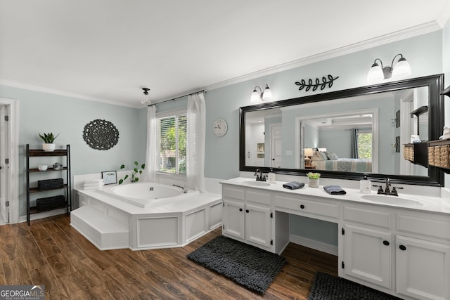 full bathroom with double vanity, a bath, ornamental molding, and a sink