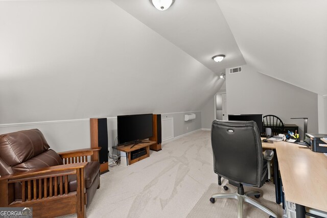 home office with vaulted ceiling, visible vents, and carpet