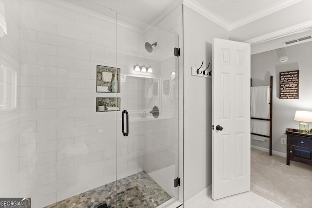 bathroom with a shower stall, baseboards, crown molding, and visible vents