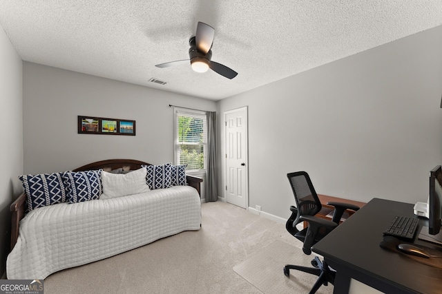 bedroom featuring a textured ceiling, ceiling fan, light carpet, baseboards, and visible vents