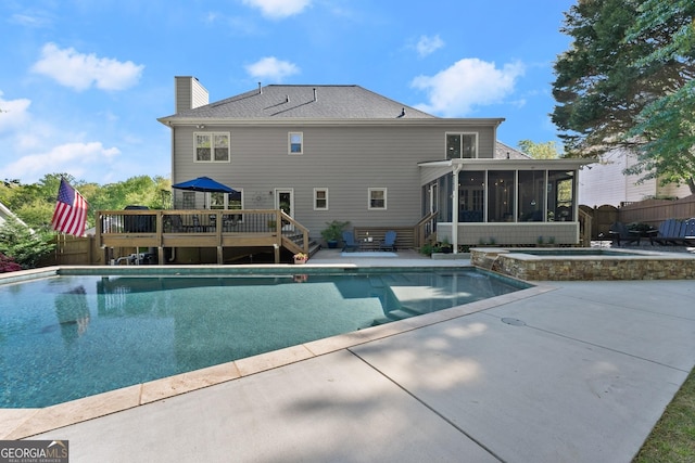 view of pool featuring a wooden deck, a patio area, a sunroom, and fence