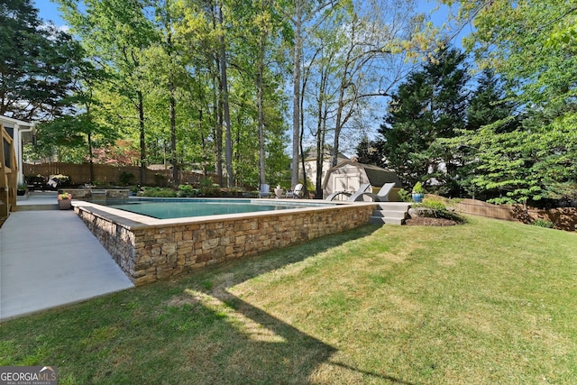 view of swimming pool with a fenced in pool, an outbuilding, a fenced backyard, a yard, and a shed