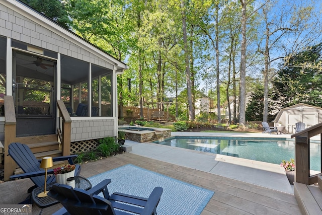 view of swimming pool featuring a sunroom, an outbuilding, a shed, and a pool with connected hot tub