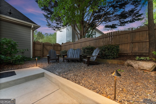 view of yard with a gate, fence, and a patio area