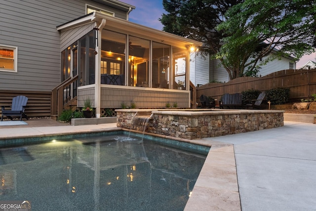 view of swimming pool with a fenced in pool, a sunroom, a patio, and fence