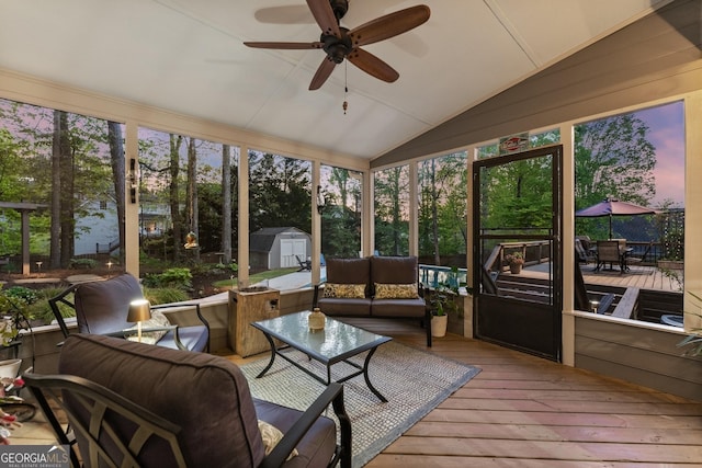 sunroom with an outdoor hangout area, outdoor dining space, and ceiling fan
